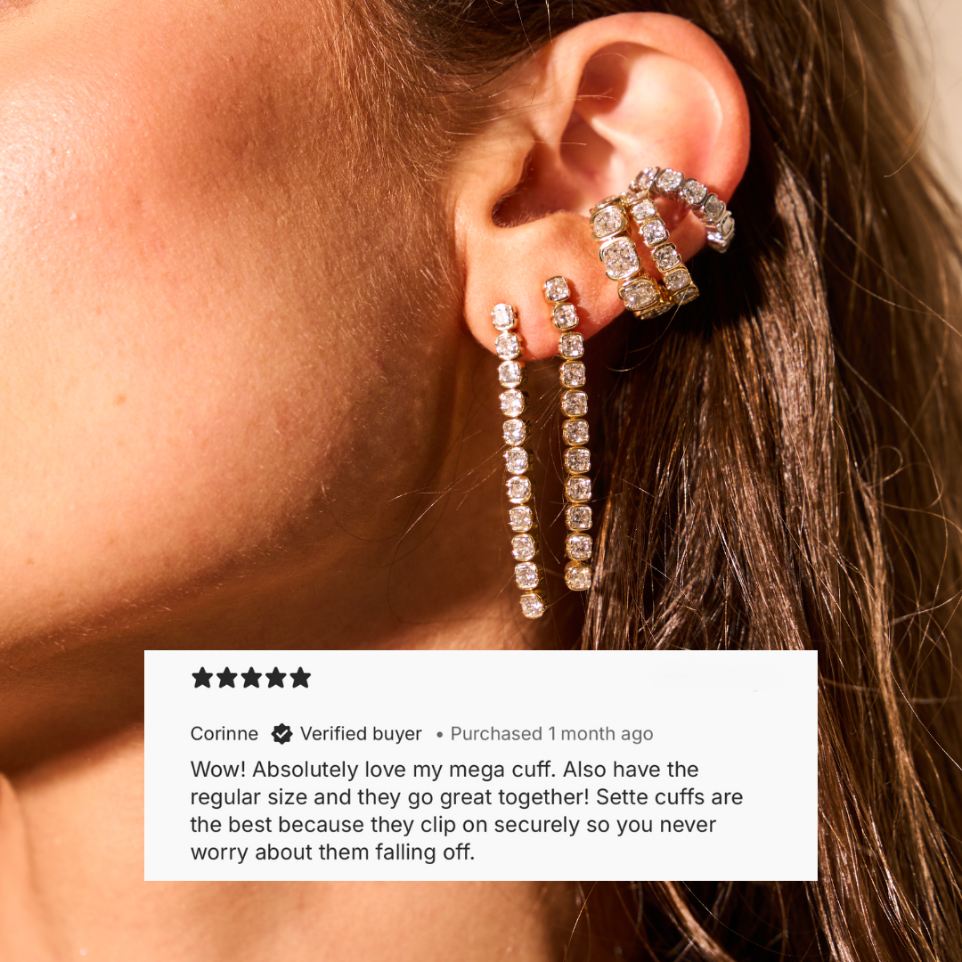 Close-up of a model wearing the Muse Mega Cushion ear cuff with cushion-cut lab diamonds in 14K yellow gold.