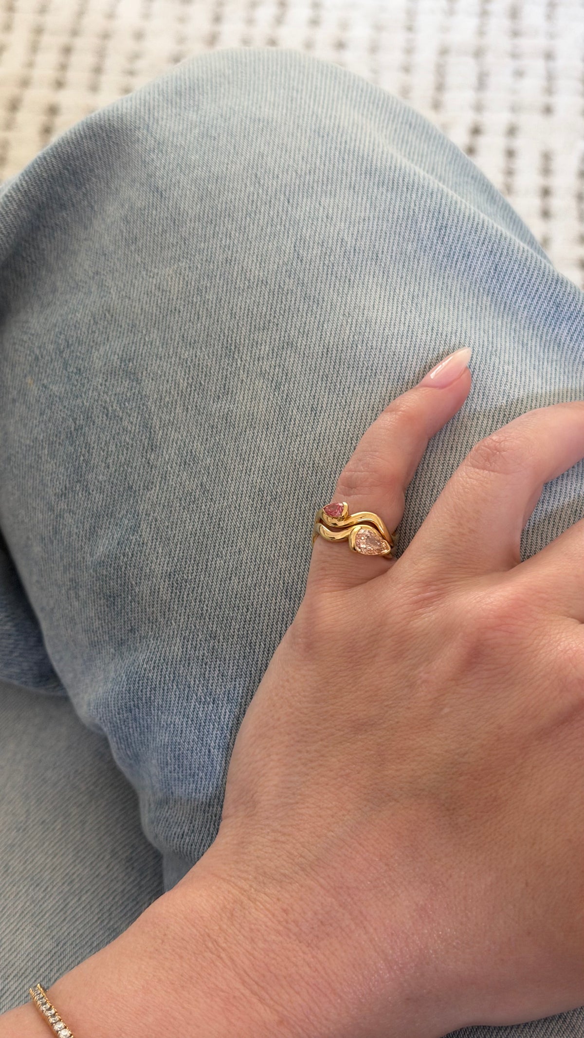 woman wearing two pink pinky rings