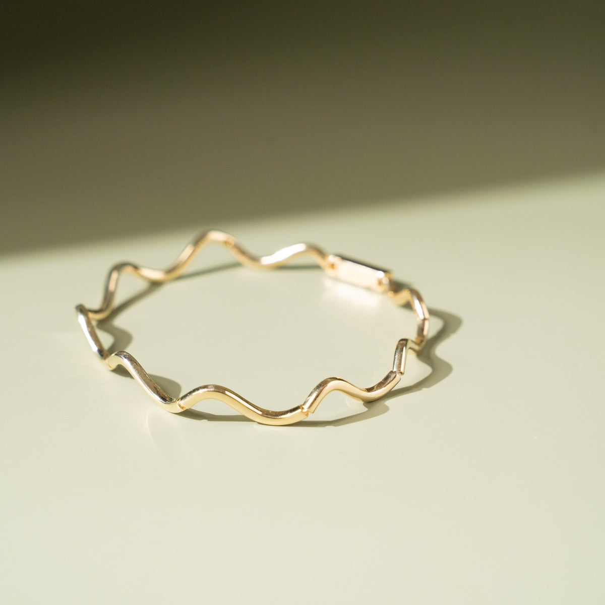 Flat lay of the bracelet displaying its full length and design details.

