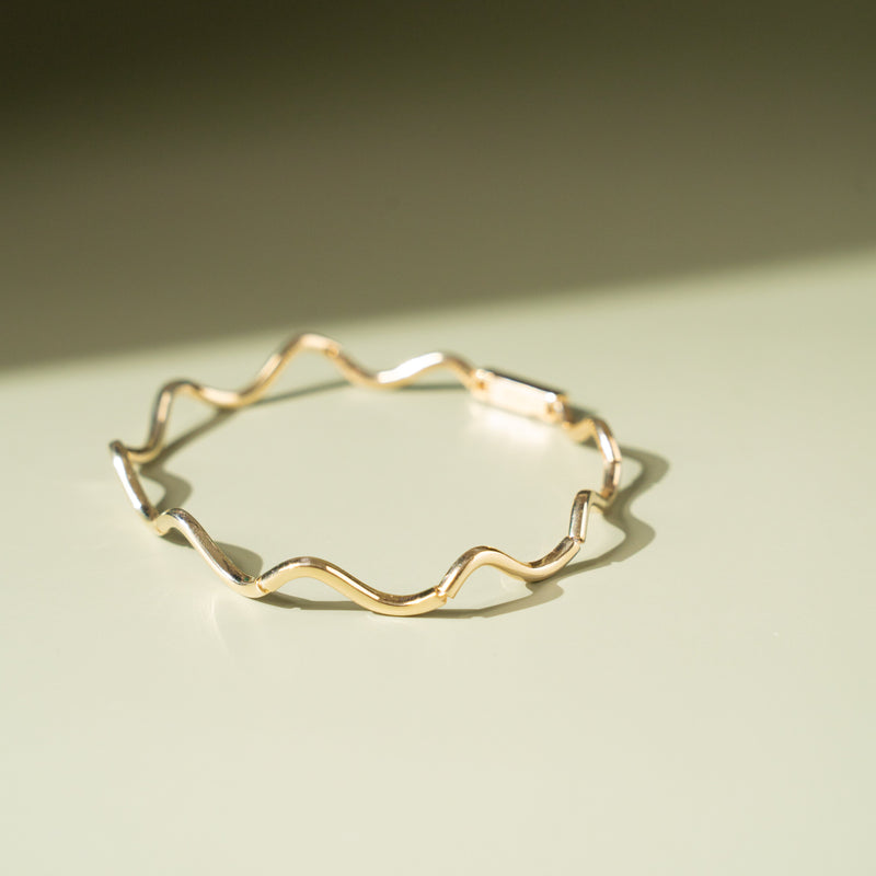 Flat lay of the bracelet displaying its full length and design details.

