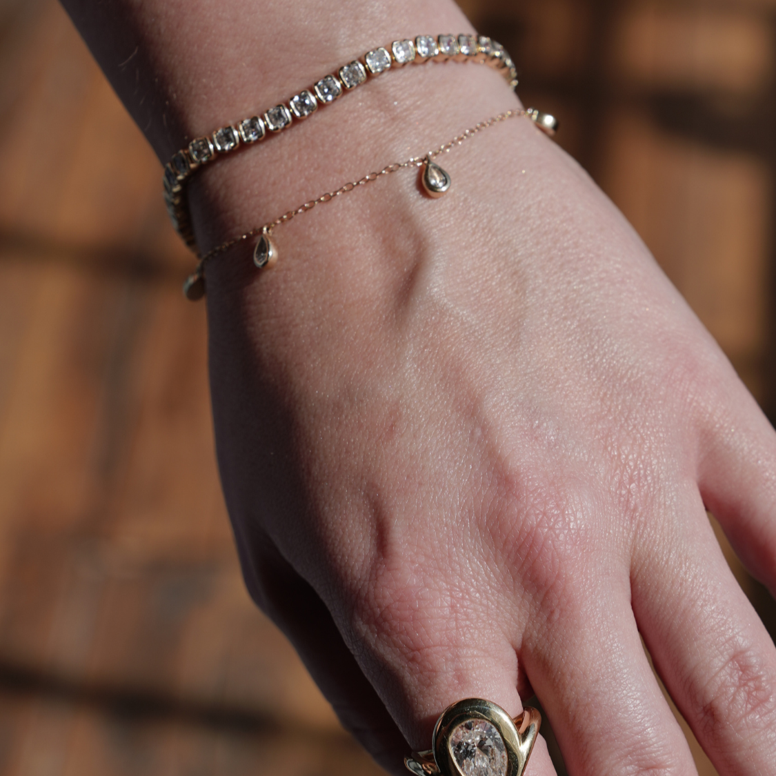 model wears tennis bracelet with other designer styles