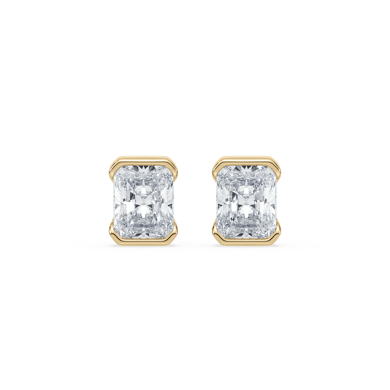 A pair of 14K yellow gold radiant cut diamond stud earrings with a bezel setting