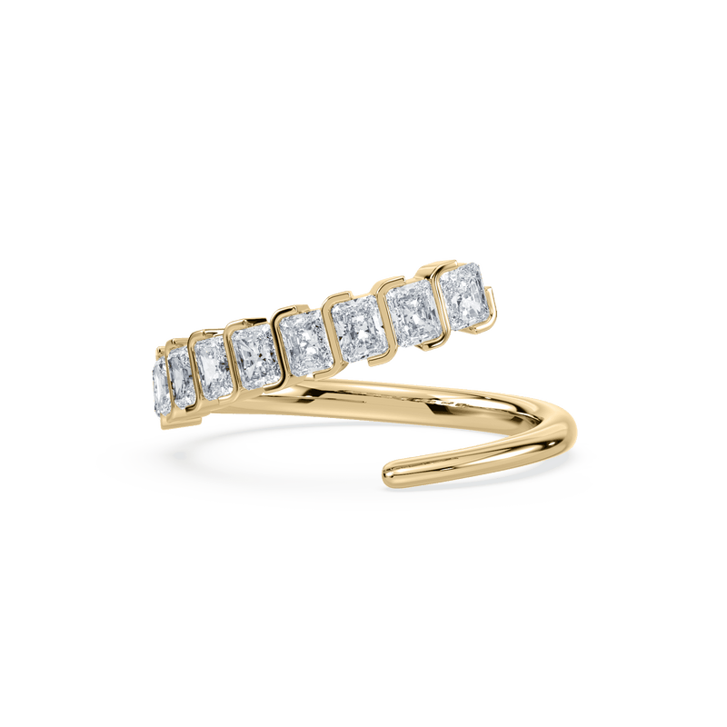 An 18K yellow gold ring with an asymmetrical radiant cut diamond design, displayed against a white background.