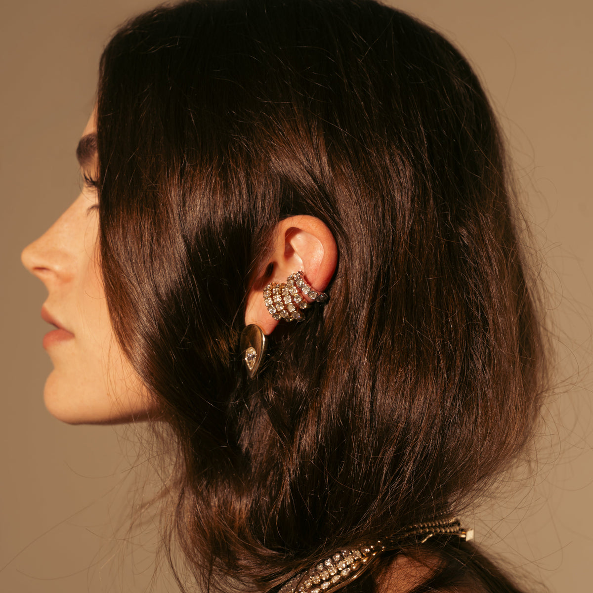 Model wearing the Muse Cascade lab diamond ear cuff in 14K yellow gold.