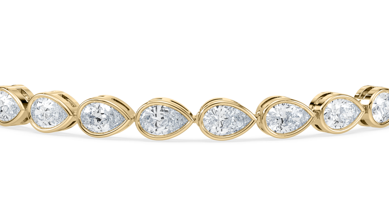 Side profile highlighting the calibrated pear-cut lab-grown diamonds.

