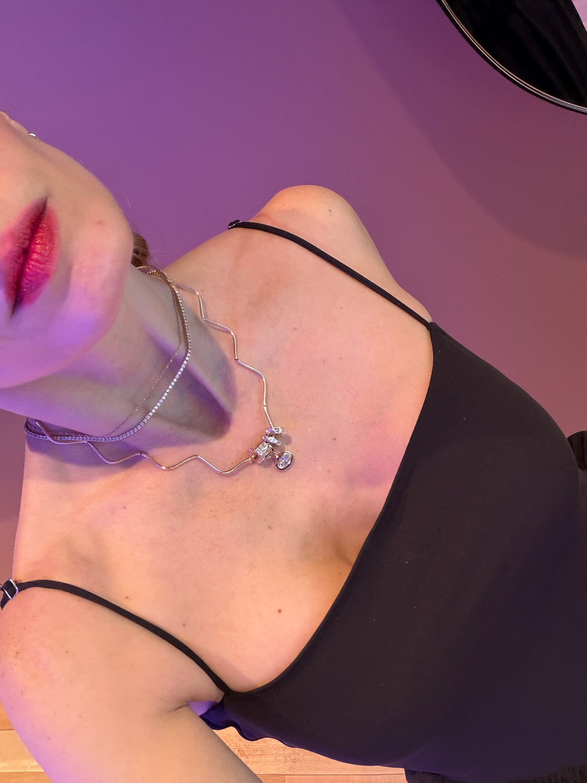 WOMAN WEARS HER NECKLACE STACK