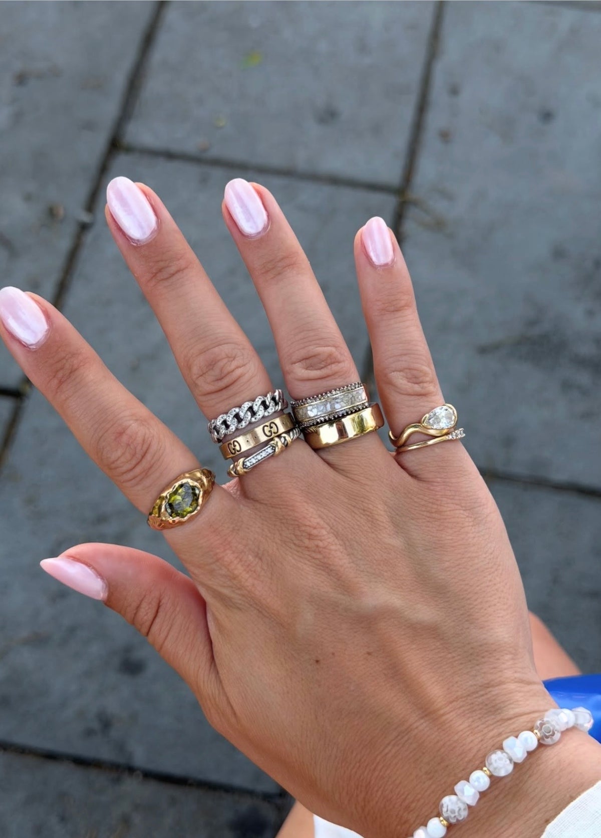 woman wearing a stack of rings
