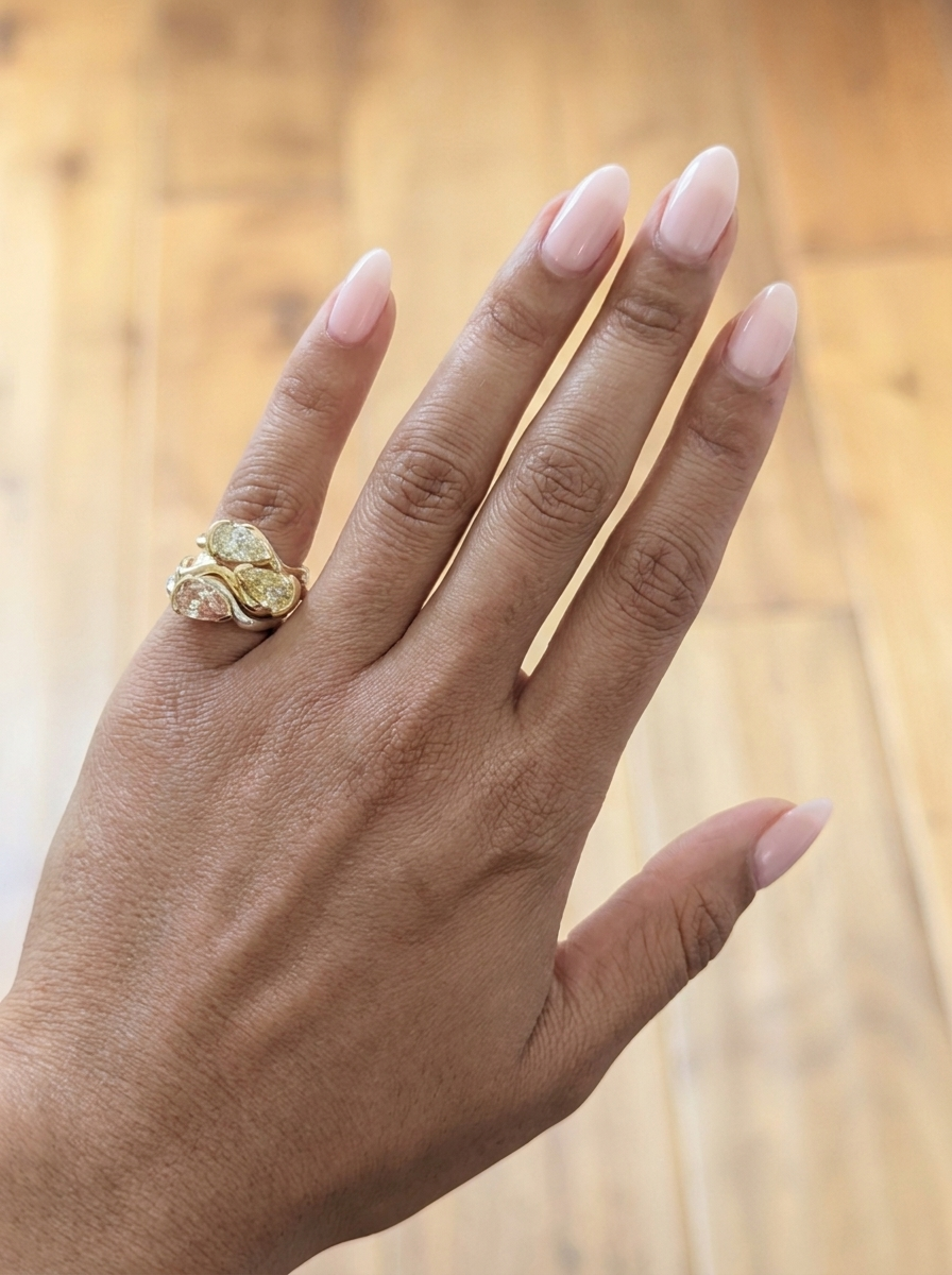 Woman wearing 3 rings stacked on her pinky ring