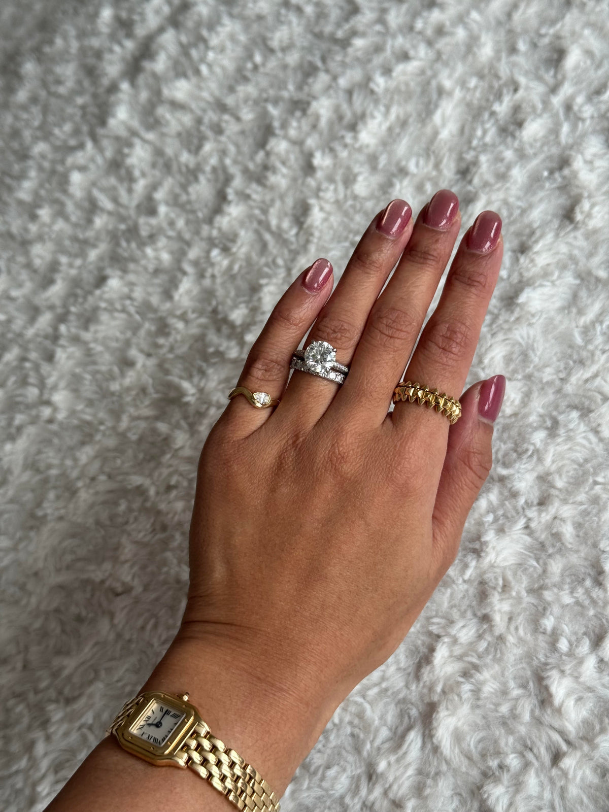 Woman wearing a dainty pinky ring with her Cartier watch