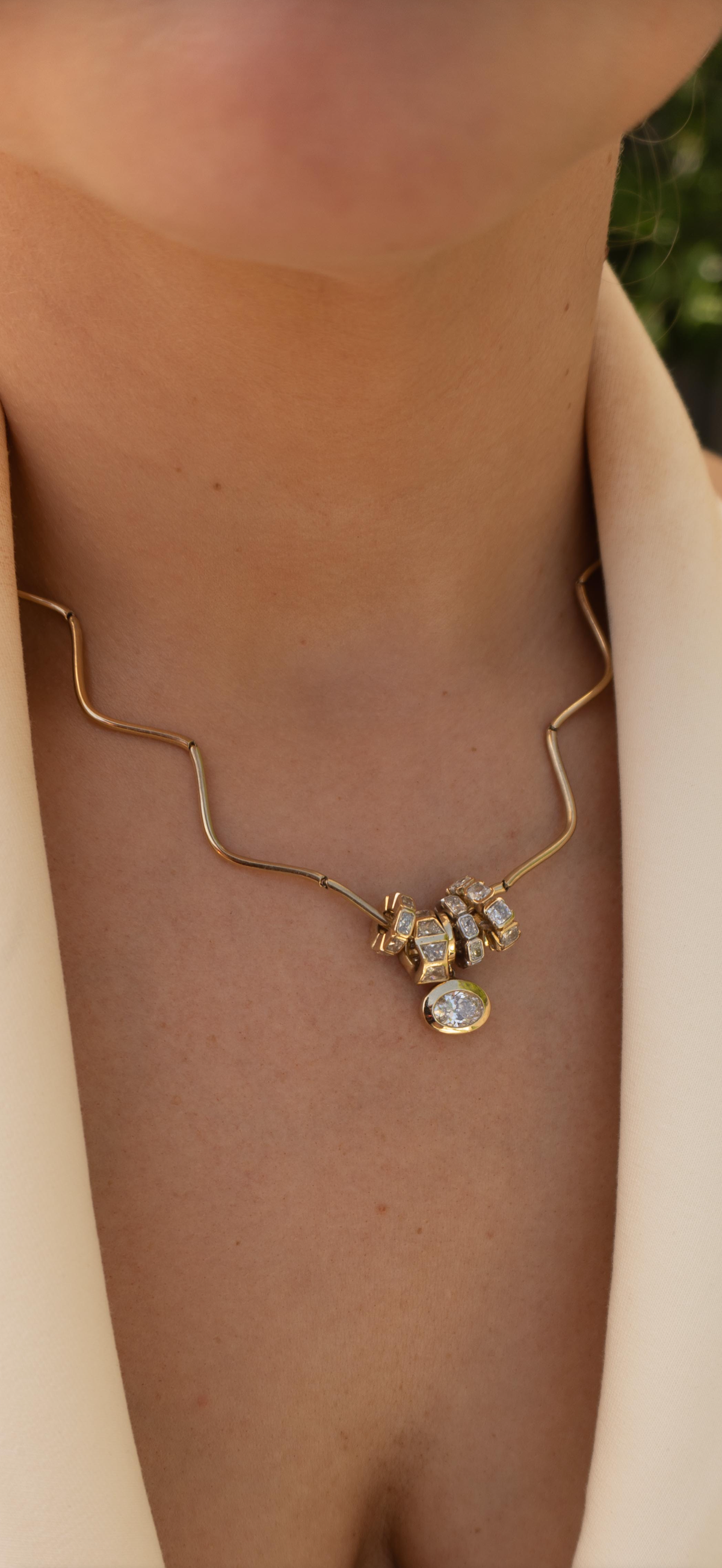 WOMAN WEARING THE COQUETTE WAVE NECKLACE AND CHARMS