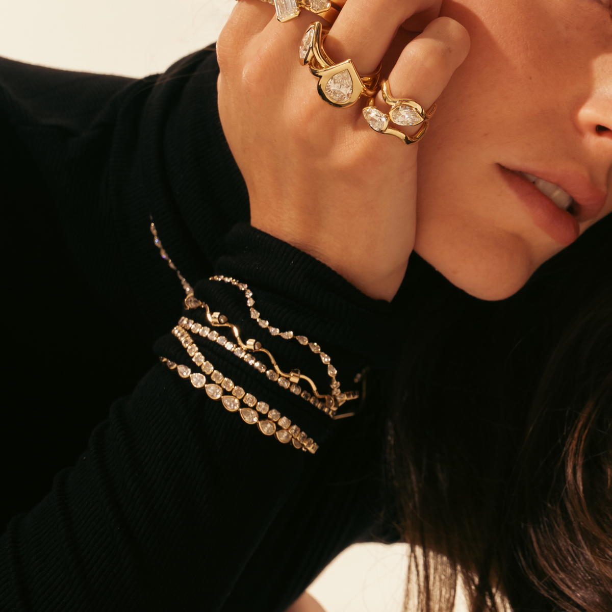 Woman wearing a maximalist fine jewelry stack