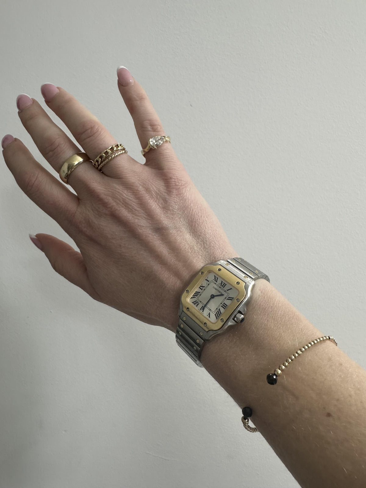 Woman wearing her 1 carat pinky ring with her Cartier and David Yurman watch