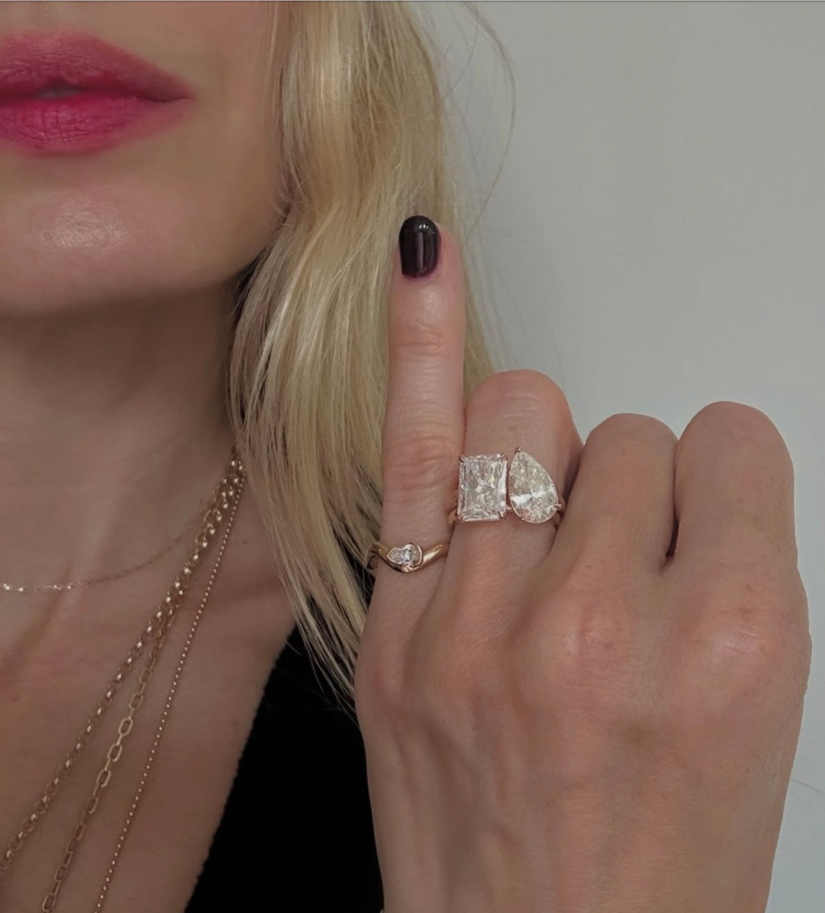 Cool girl wearing a cute pinky ring next to her iconic engagement and wedding ring stack