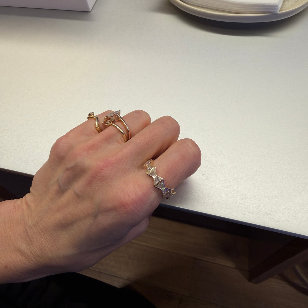 WOMAN WEARING DECO ETERNITY BAND ON POINTER FINGER