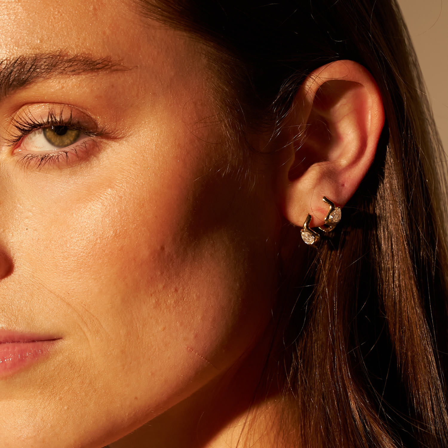 model wearing both coquette hoops on one ear