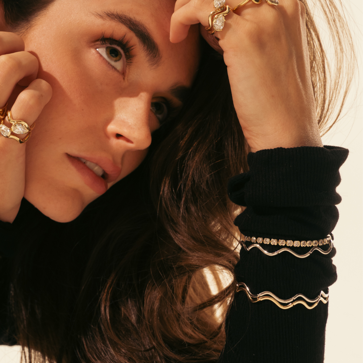 Model wearing multiple bracelets