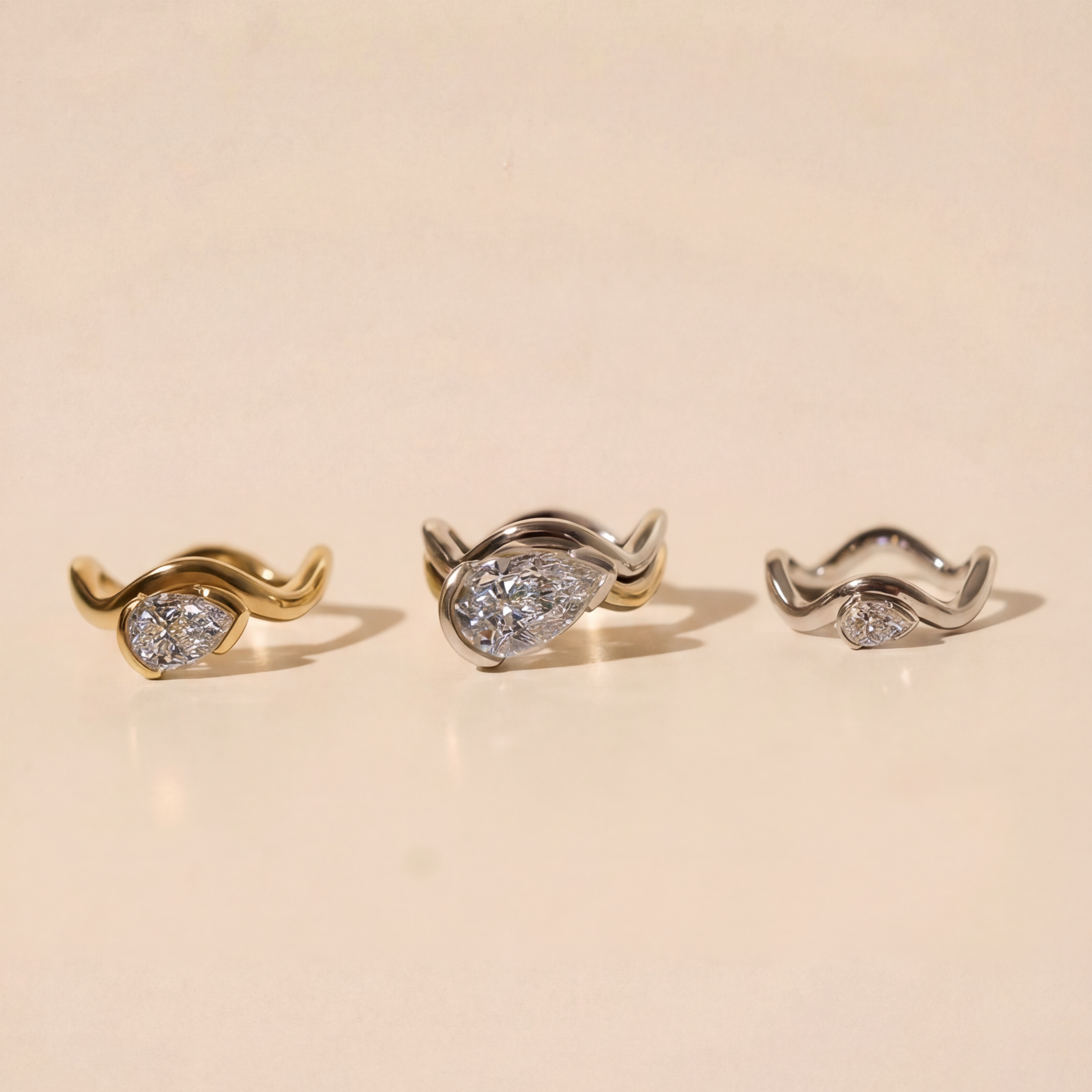 Three pairs of rings on a beige background