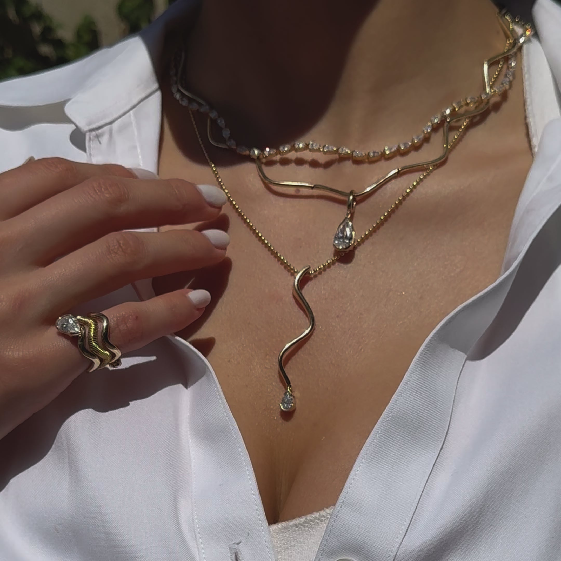 Model wearing the Coquette Wave Necklace layered with other SETTE pieces.

