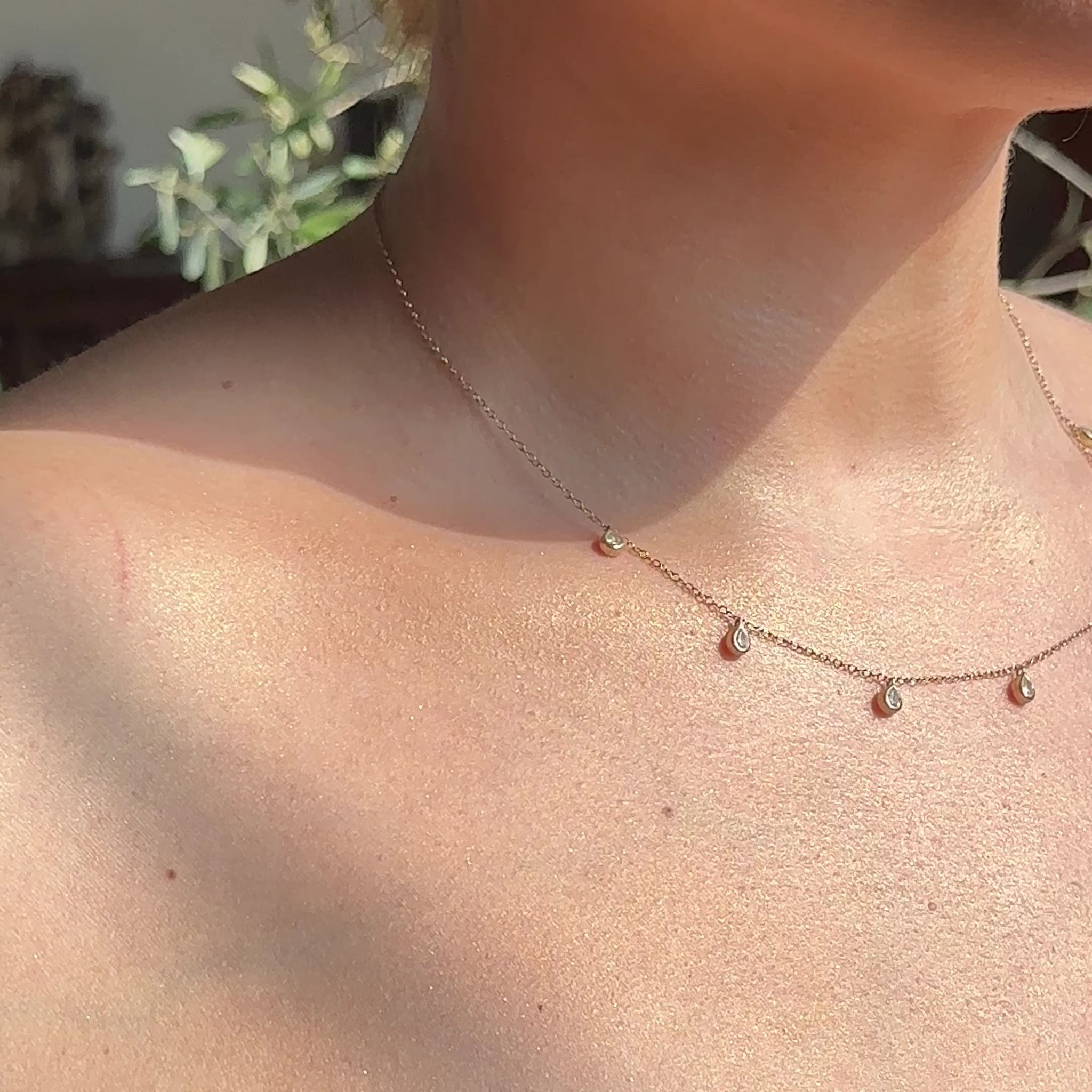 model wearing aura silver lab diamond necklace with pear cut lab diamonds