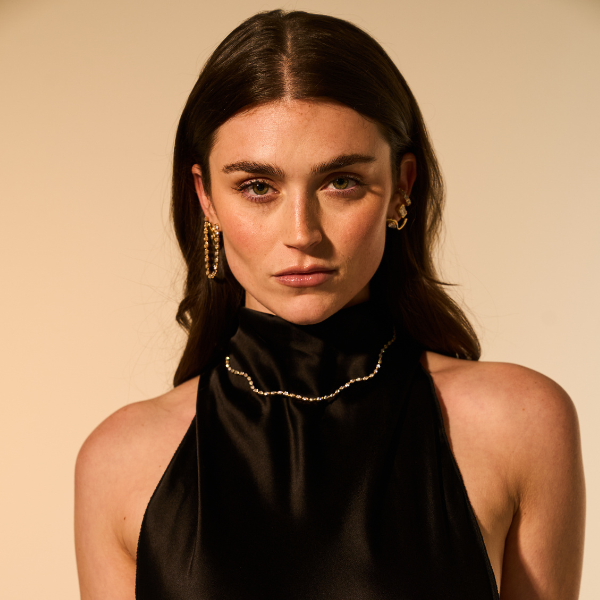 woman wearing cool jewelry and a black dress