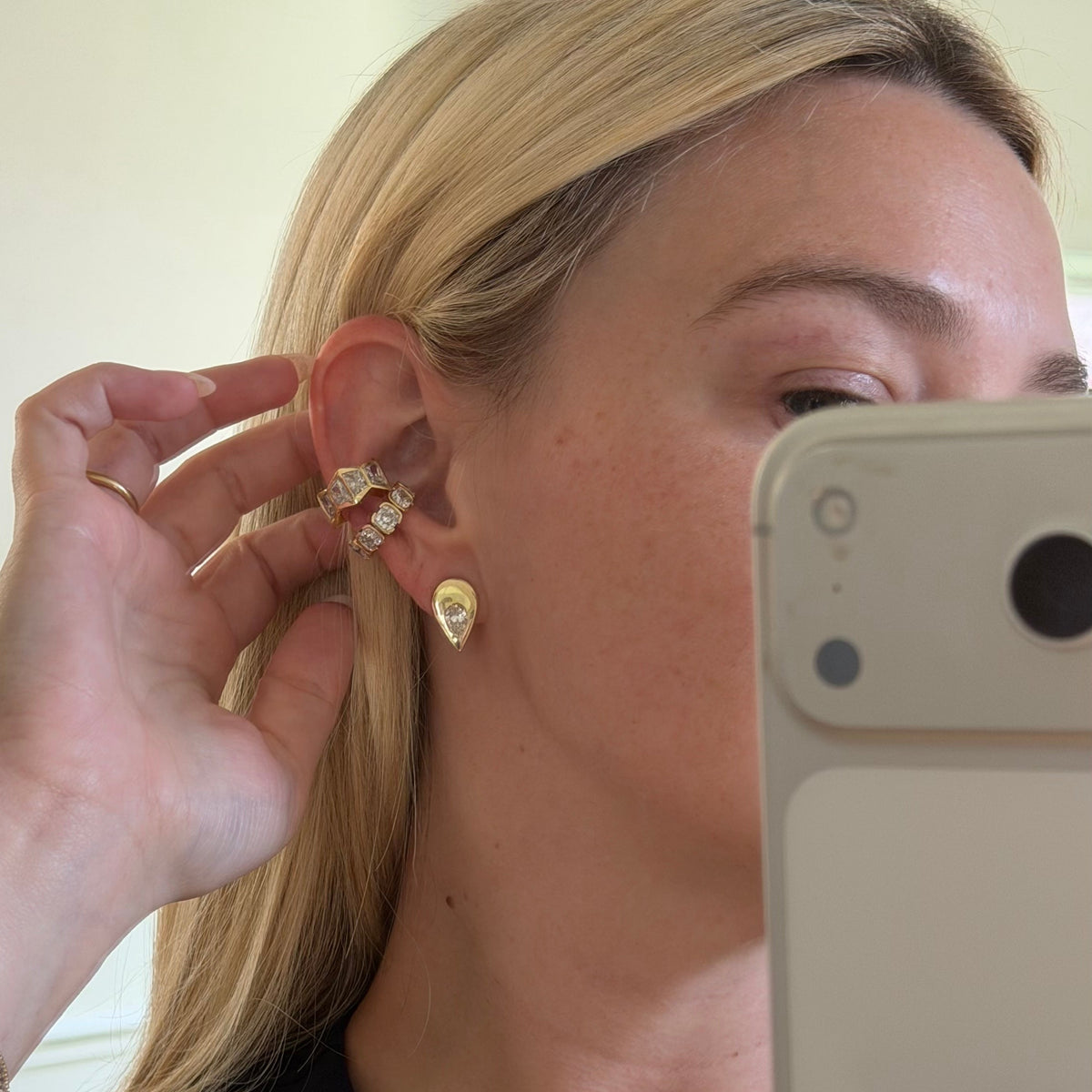 woman showing off earrings