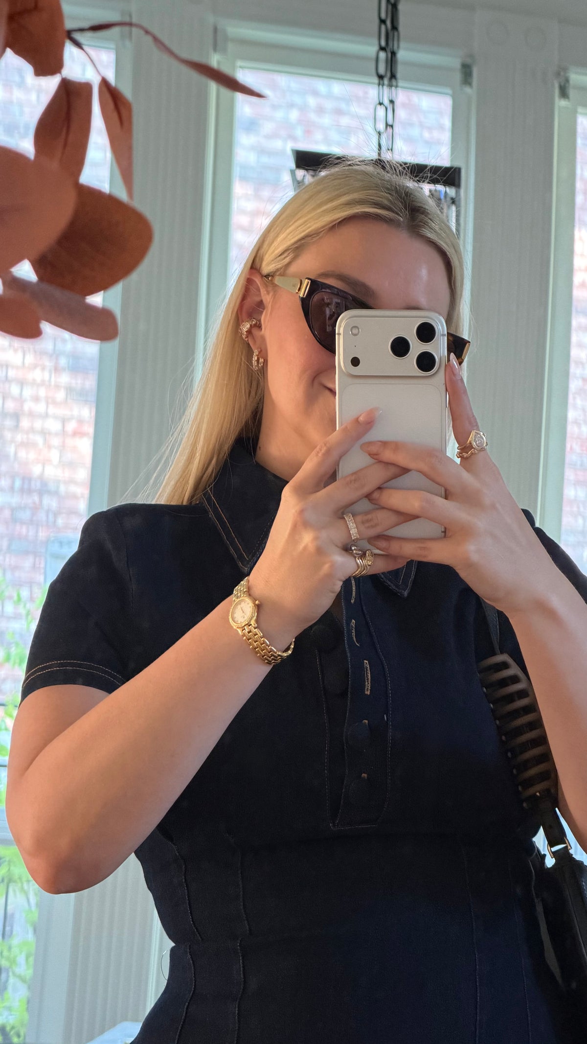 woman taking photo of outfit and jewelry