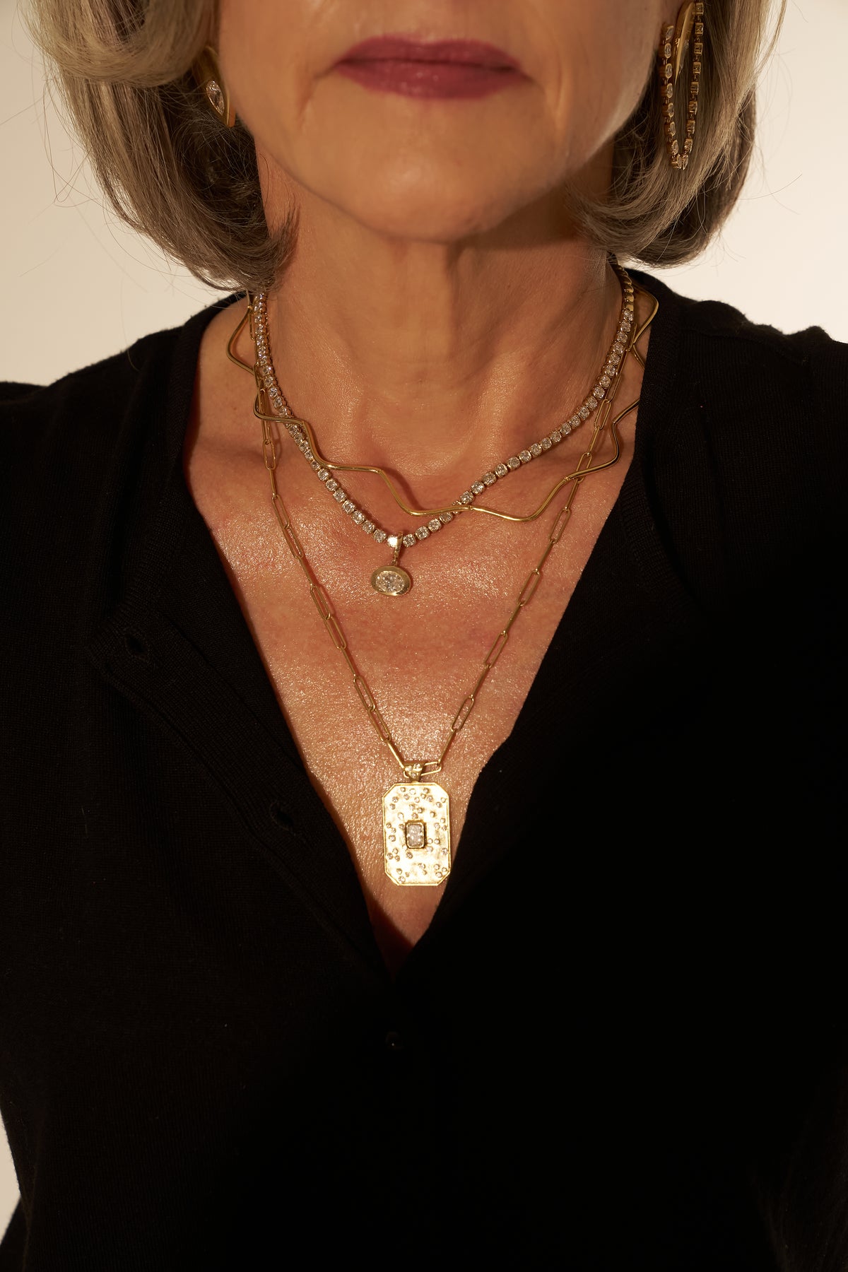 woman wearing a stack of necklaces
