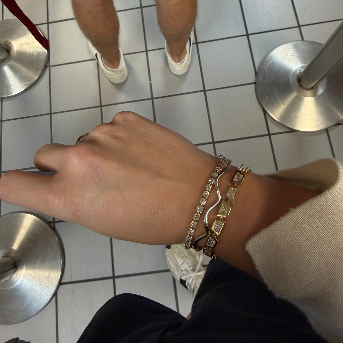 woman at airport wearing a bracelet stack