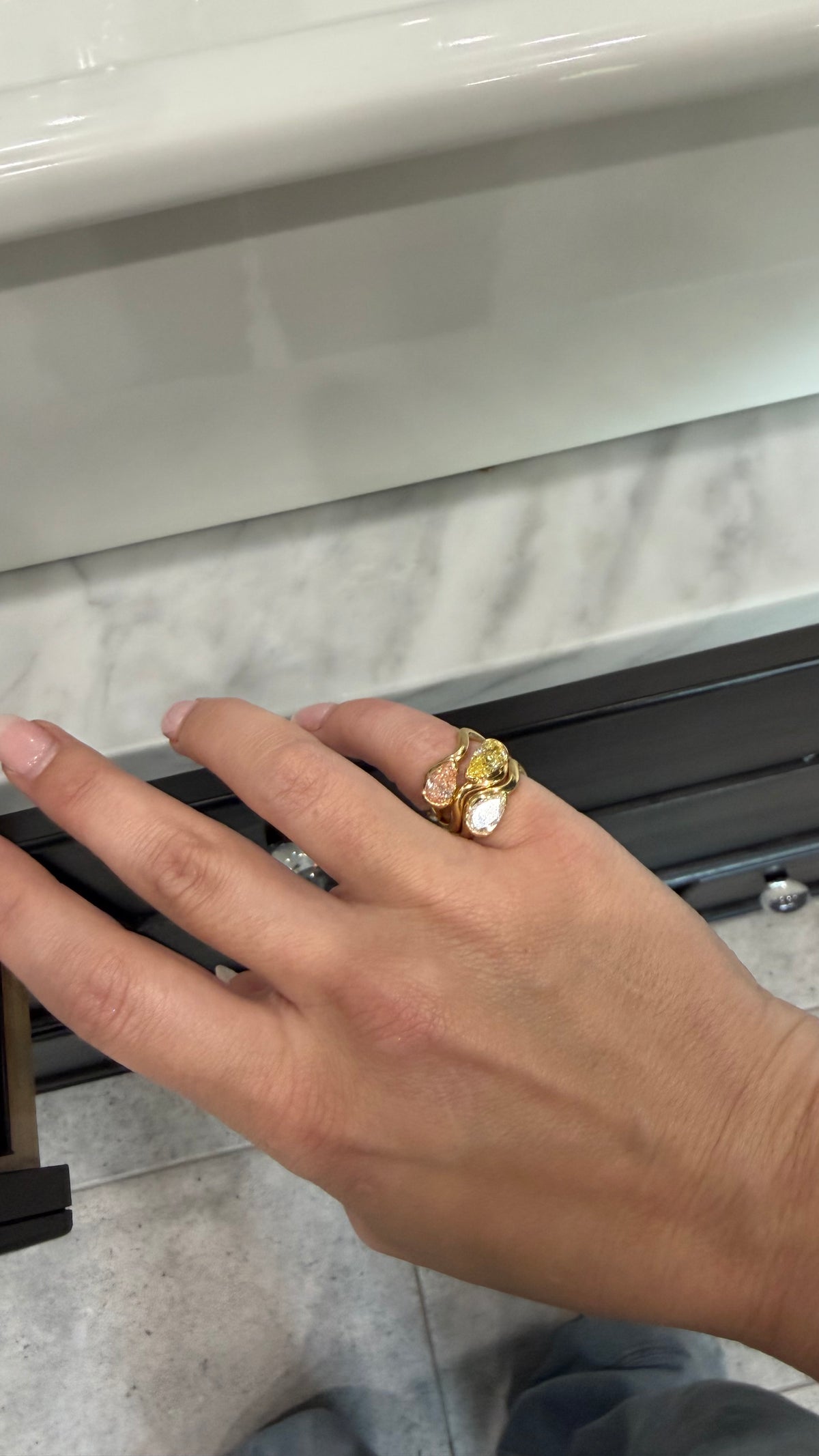 woman wearing multiple color pinky rings